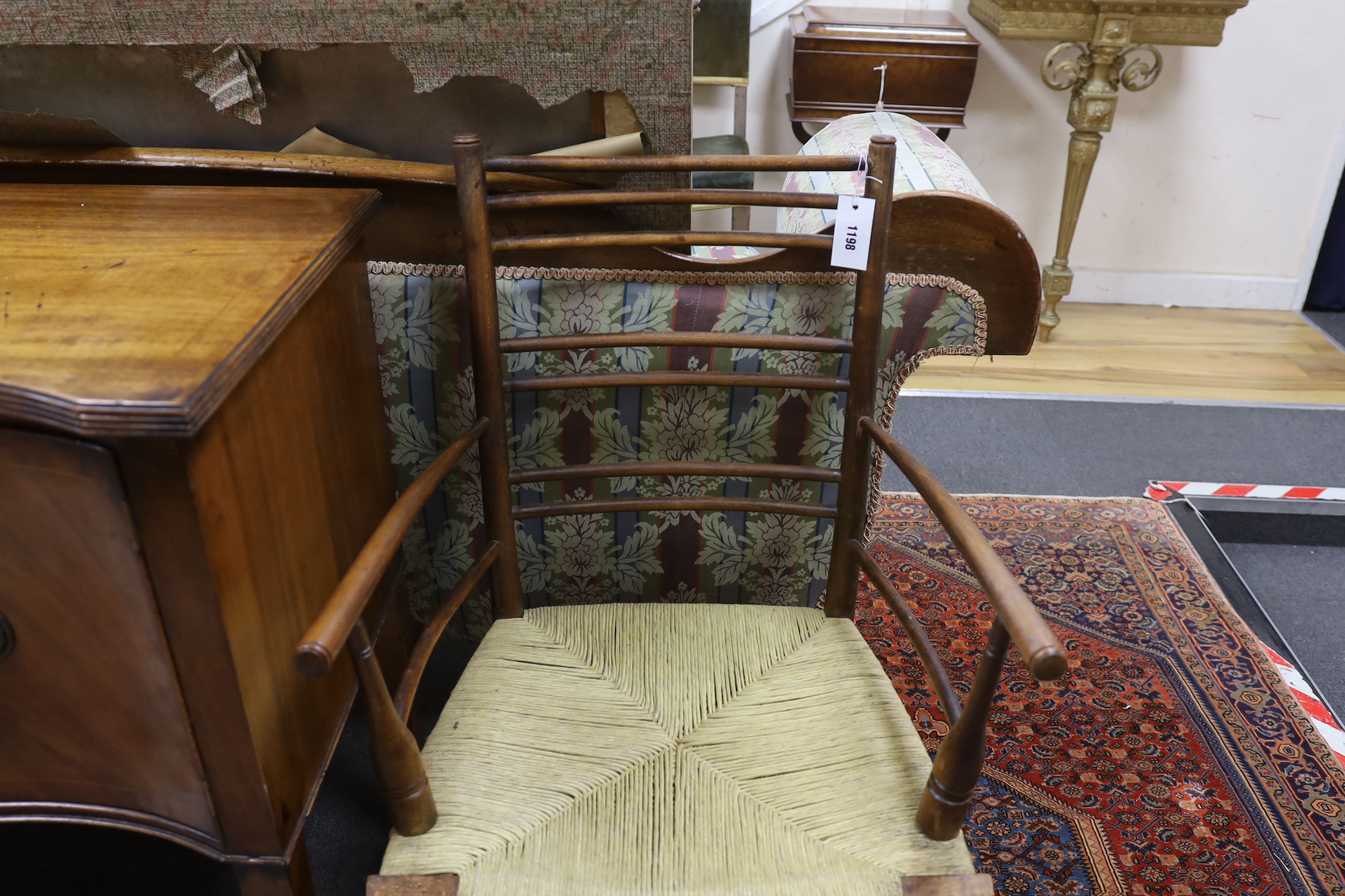 A William Morris style beech and fruitwood rush seated elbow chair